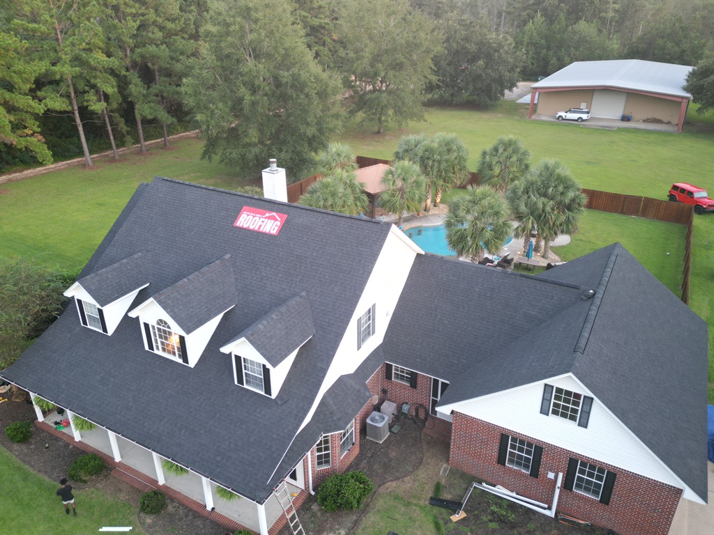 Roofer installing standing-seam metal panels